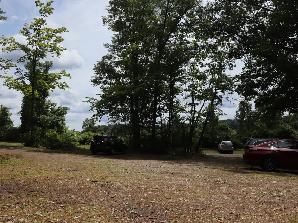 Main parking for the Sandy Beach at Laurel Lake, which is in a hilly, dirt area.