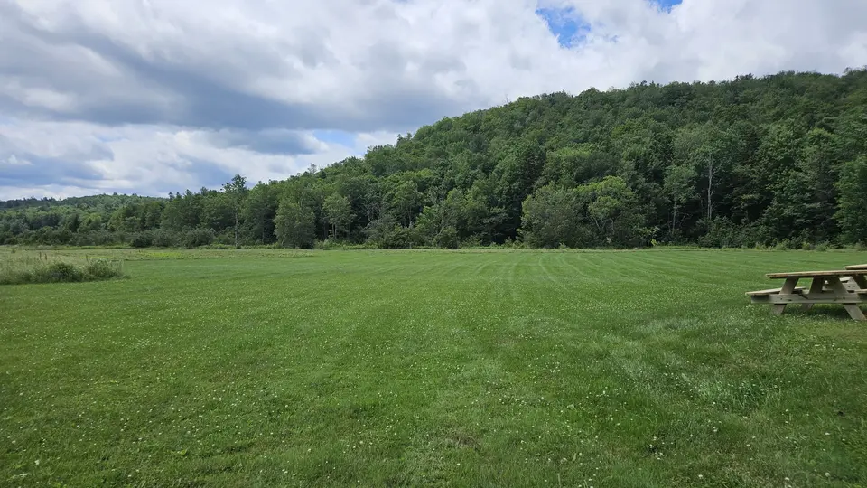 The large, flat grass field.