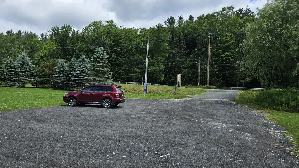 The entrance to the Town Park, with a gravel parking lot.