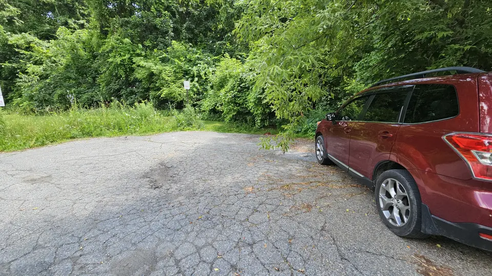The small cracked pavement parking area.