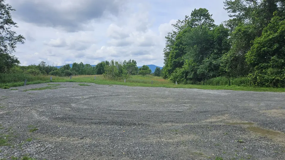 The large uneven gravel parking lot.