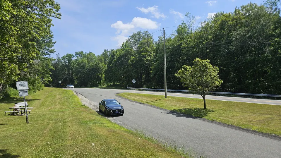 A paved area for parking, off the main road.
