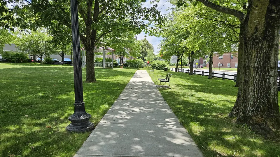 A sidewalk through the park.