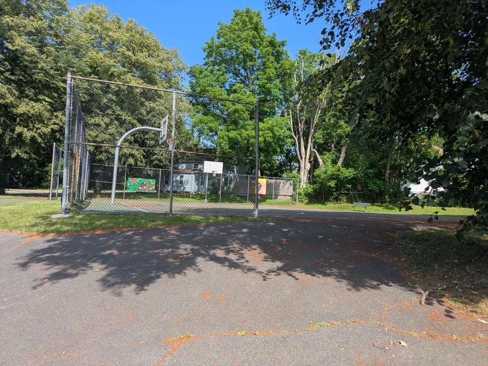 Steep path leading to basketball courts from street