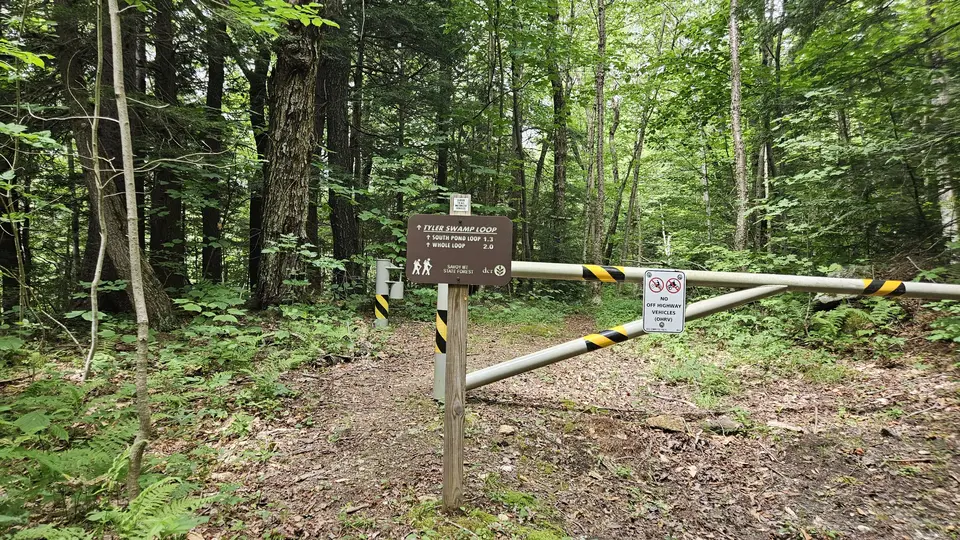 The trailhead, with a fence and a sign.