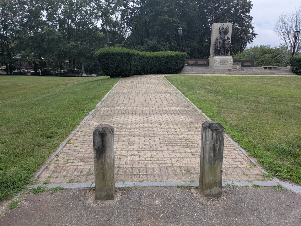 Wooden bollards in front of the path to the memorial