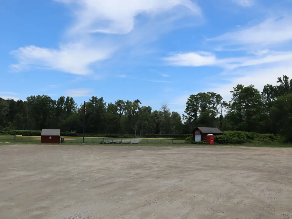 A flat, dirt lot which provides parking for War Memorial Field.