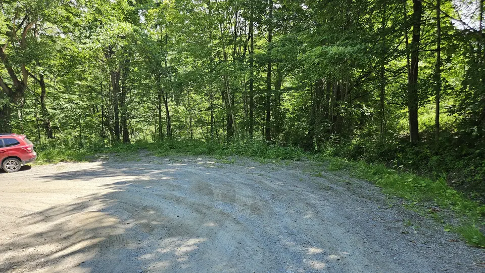 The gravel parking area.