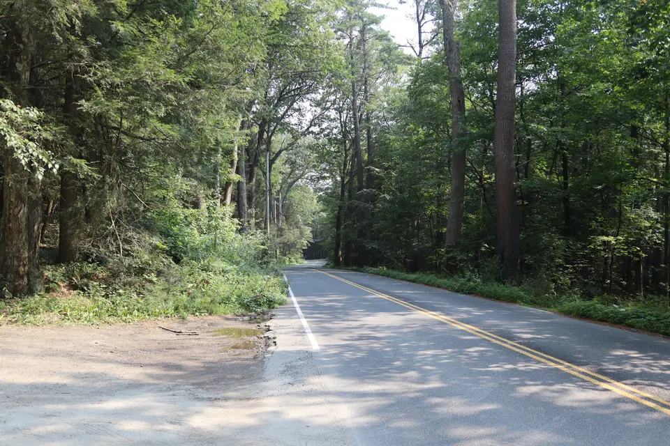 Entrance to the parking area for the Brothers Trail (left) from Richmond Mountain Road, facing southeast.