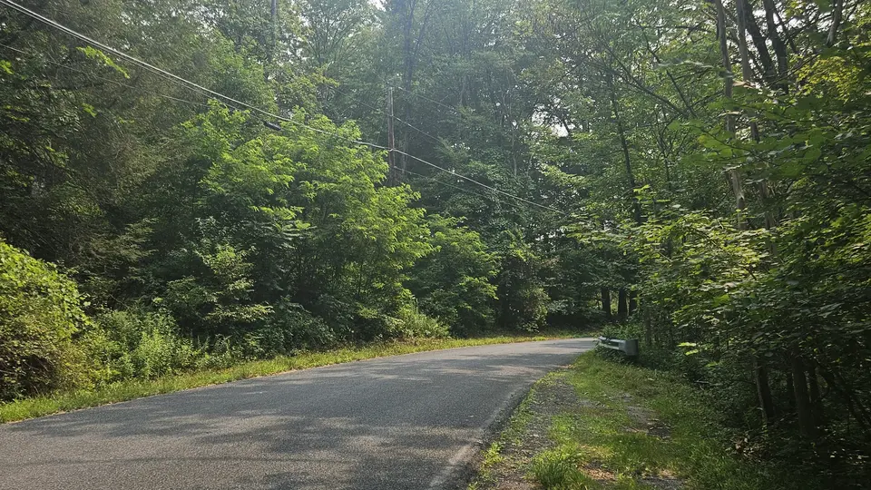 The paved road that leads to the trail.