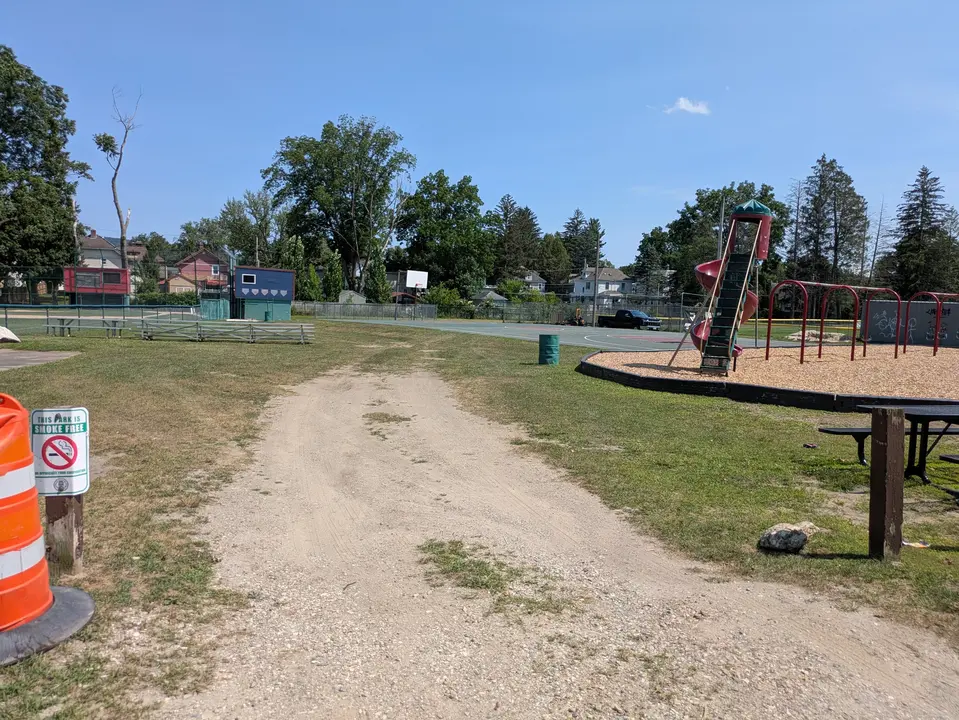 Grassy gravel path the basketball courts at Deming Park