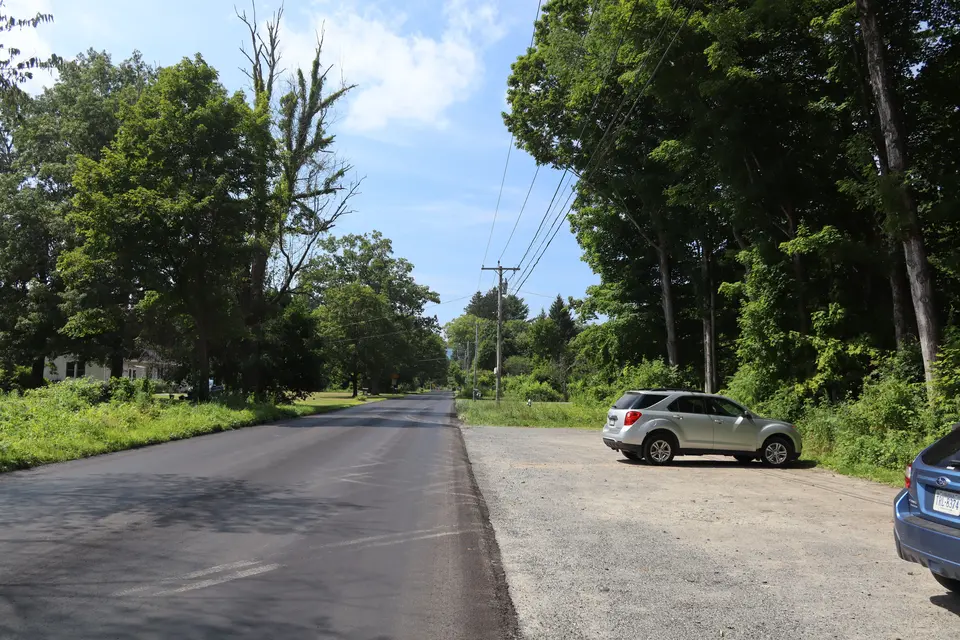 Entrance to the parking area for the Flag Rock Trailhead (right), off Park Street, facing northwest.