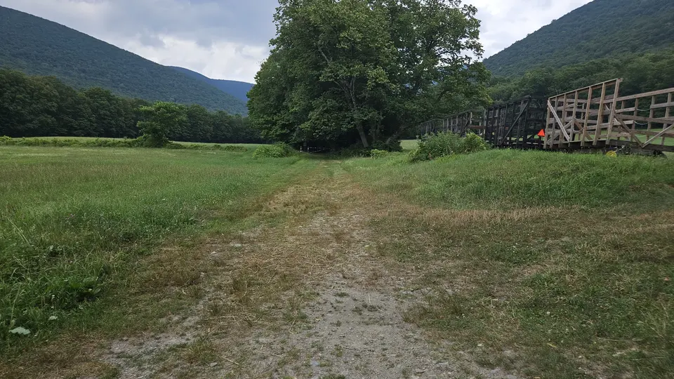 A grass path connecting the parking lot to the Haley Farm trailhead.