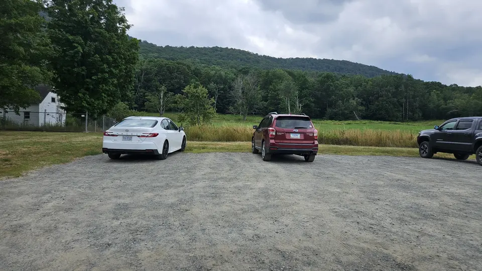 The flat gravel parking lot.