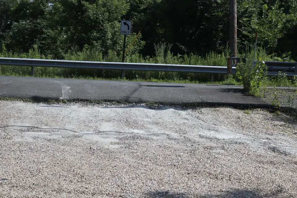Steep lip separates Division Street from the Housatonic River access parking area.