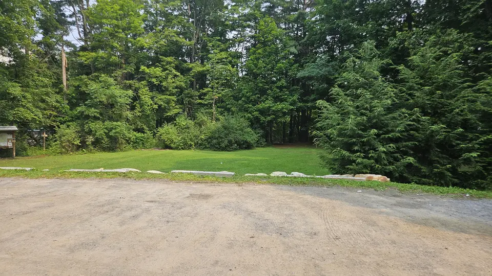 The flat, dirt parking lot.