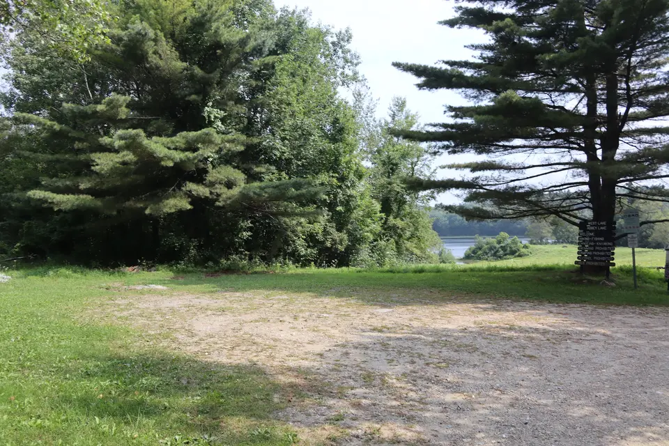 Parking area located adjacent to West Street, which sits over flat, compact dirt and grass.